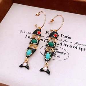 Vintage gold fish earrings with black enamel and colorful beads on bohemian tassels
