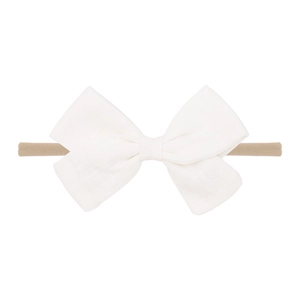 Detail of soft off-white cotton linen baby headband with a large handmade bow knot