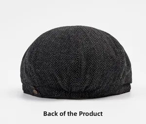 Detailed back view of dark grey herringbone beret cap with vintage metal button fastener