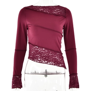 Detailed view of burgundy slim fit top featuring asymmetric lace patchwork and hem