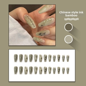 Detail of green ink bamboo press-on nails set with traditional Chinese calligraphy