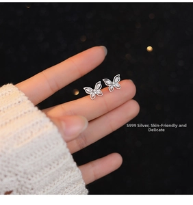 Detailed shot of S999 sterling silver butterfly studs with sparkling zircon accents