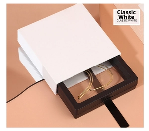 Close-up of classic white PE film floating jewelry box with a gold chain display