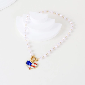 Detail of USA flag heart pendant with sparkling rhinestones and white pearl beads necklace