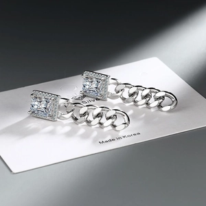 Detail of silver chain earrings with rectangular zircon studs on display card