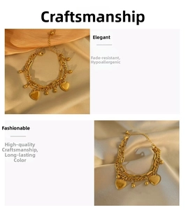 Detail of layered gold titanium steel bracelet featuring heart charms on silk fabric