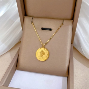 Minimalist gold coin necklace with Queen Elizabeth II pendant in a beige gift box
