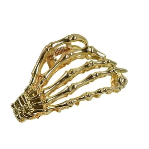 Golden skeleton hand hair claw clip in spider web metal design for Halloween hairstyle