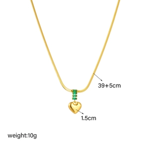 Retro gold titanium steel necklace with heart pendant and green stones on white background