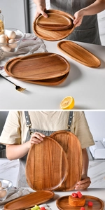 Close-up of acacia wood pizza trays with natural grain and smooth rounded edges