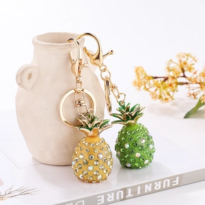 Sparkling crystal-studded pineapple keychain in vibrant yellow and green with gold plating