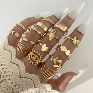 Close-up of gold ring set with minimalist geometric patterns and pearl accents