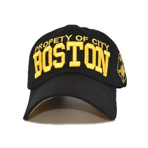 Detail of Boston embroidery and compass patch on black cotton baseball cap