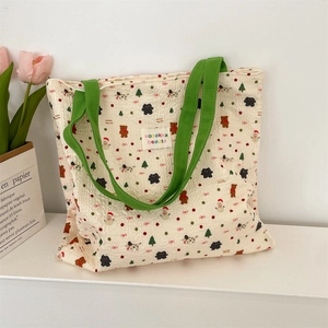 Detail of cute bear and Christmas tree print on cream canvas shoulder shopping bag