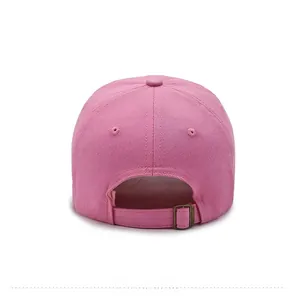 Detailed back view of pink cotton baseball cap featuring adjustable bronze metal buckle