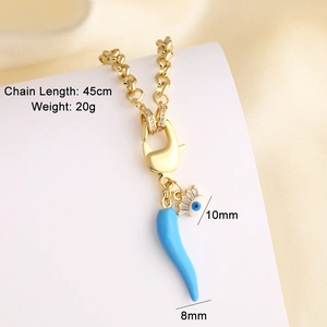 Detail of 18k gold plated chunky chain with blue chili and devil eye charms