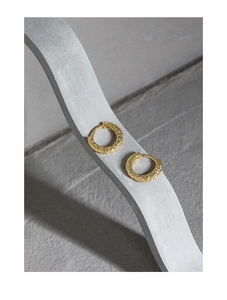 Close-up of S925 sterling silver hoop earrings with a textured hammered gold finish