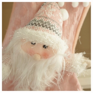Detailed macro view of 3D Santa plush with pink knit hat and glittering white beard