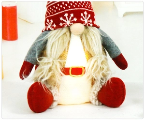 Detail of a Christmas gnome featuring a red knit hat and warm white glowing LED body