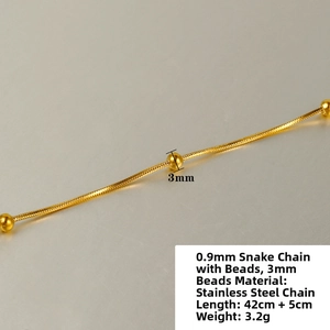 Macro detail of 0.9mm gold stainless steel snake chain necklace with 3mm beads