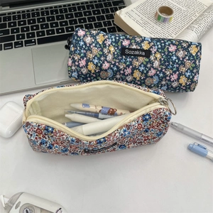 Detail of floral canvas pouches showing large capacity for stationery and cosmetics