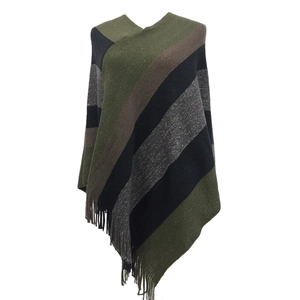 Detail showing the colorful striped knit texture and soft fringe hem of this poncho