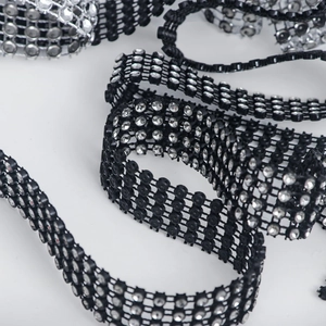 Macro shot of 24-row black mesh rhinestone trim with silver faux diamonds for DIY decor