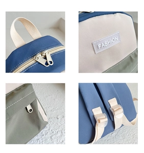 Detailed close-up of handles, zipper, straps, and stitching on the canvas backpack