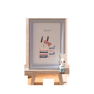 Cute 4x6 inch wooden photo frame with blue interior and rabbit illustration on easel