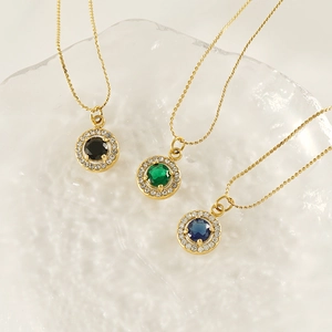 Three 18K gold-plated necklaces with emerald, sapphire, and black zircon halo pendants
