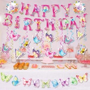 Butterfly birthday party banners and hanging swirls over a decorated dessert table