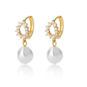 Detail of gold teardrop pearl earrings with cubic zirconia pave on a white reflective base