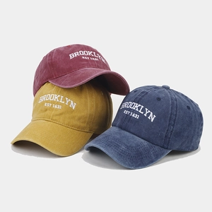 Close-up of three washed cotton baseball caps featuring Brooklyn EST 1631 embroidery