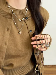 Macro detail of Tiger Eye stone beads and a wooden horse pendant on a double-layer necklace