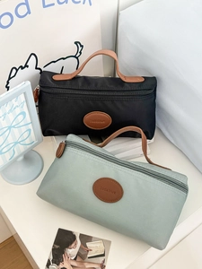 Detail of waterproof nylon toiletry bags with brown leather handles and Sodablue logo