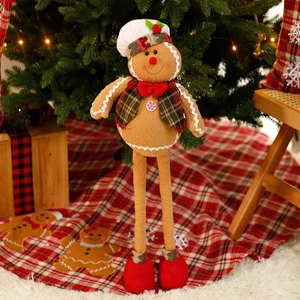 Christmas gingerbread man plush doll with chef hat and plaid vest by Xmas tree