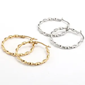 Polished twist hoop earrings set in shiny gold and silver tones with secure clasp