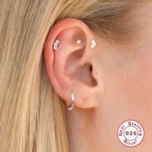 S925 sterling silver piercing earrings set with cubic zirconia on female model ear