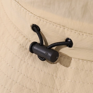 Detail of adjustable drawstring and khaki quick-dry fabric on kids bucket hat