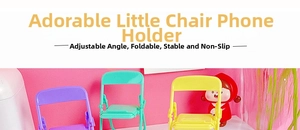 Foldable chair phone holder in purple, mint green, and yellow on a pink desk background