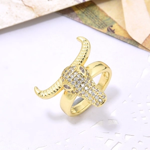 Detailed close-up of a gold bull head ring with micro-pave cubic zirconia on lace