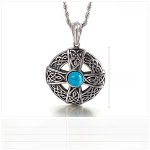 Macro detail of retro stainless steel Celtic cross pendant with turquoise inlay