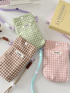 Plaid fabric phone pouch with adjustable strap in green, brown, and pink colors