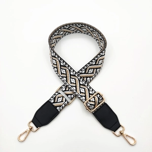 Ethnic geometric woven shoulder strap with black leather ends and gold metal buckles