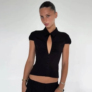 Detail of black short sleeve top featuring lapel collar and trendy teardrop cutout design