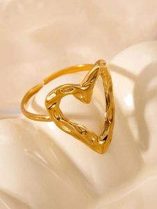 Macro shot of gold hollow heart ring with lava texture and adjustable opening