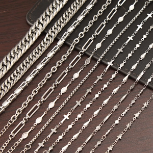 Assorted silver stainless steel necklaces featuring Cuban, cross, and star chain designs