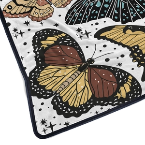 Soft flannel blanket featuring vintage butterfly prints and navy blue stitched edges