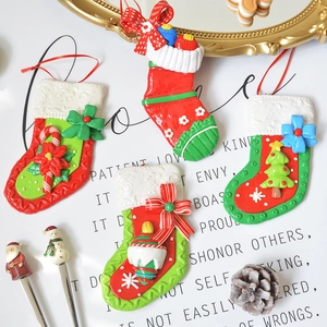 Set of 4 festive Christmas stocking ornaments with tree and bow designs for holiday decor
