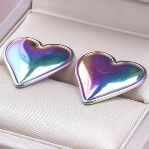 Macro shot of heart-shaped stainless steel earrings with iridescent rainbow plating finish